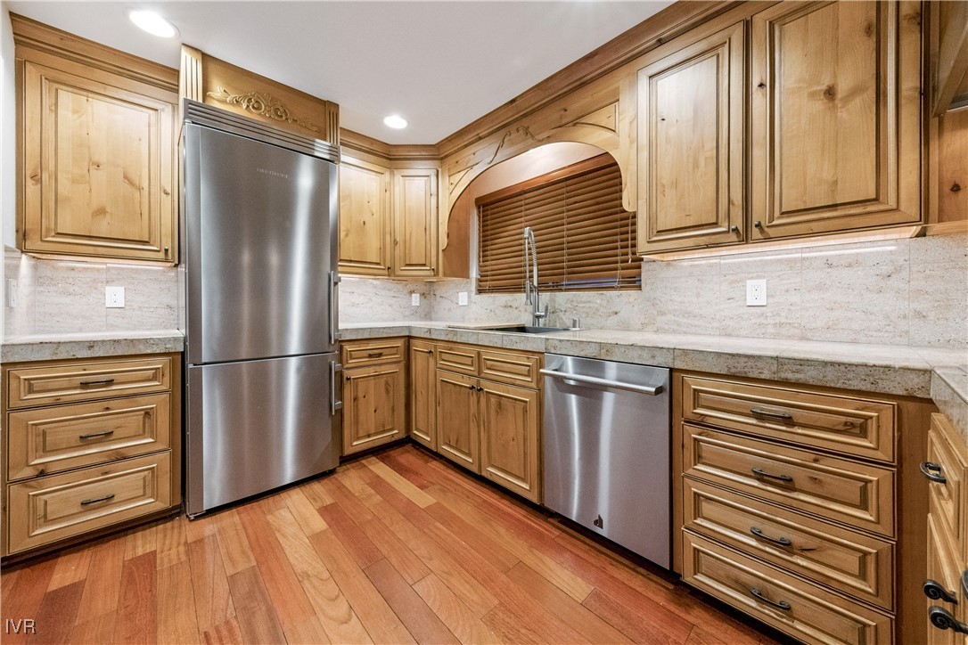 771 Randall Avenue Incline Village, NV 89451 - Photo 13 of 44 a kitchen with stainless steel appliances granite countertop a refrigerator a sink dishwasher a stove and a refrigerator with wooden floor