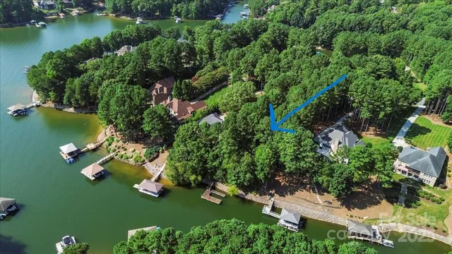 an aerial view of a house with a yard basket ball court and outdoor seating