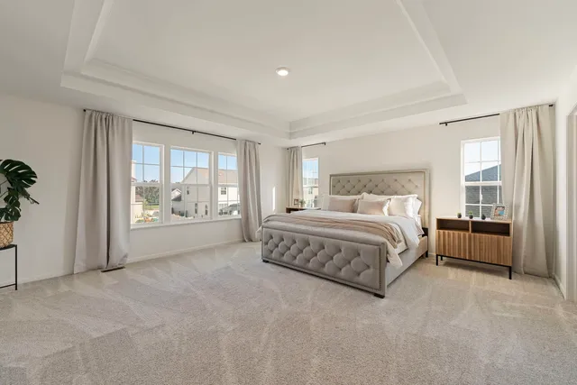 a spacious bedroom with a large bed and a large window