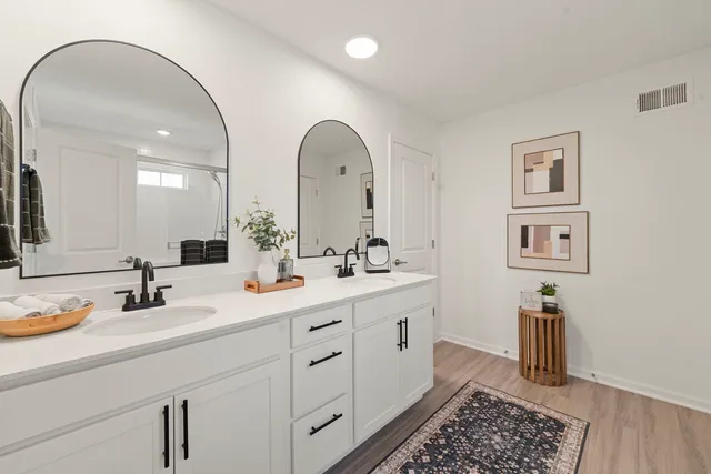 a bathroom with a double vanity sink and a mirror