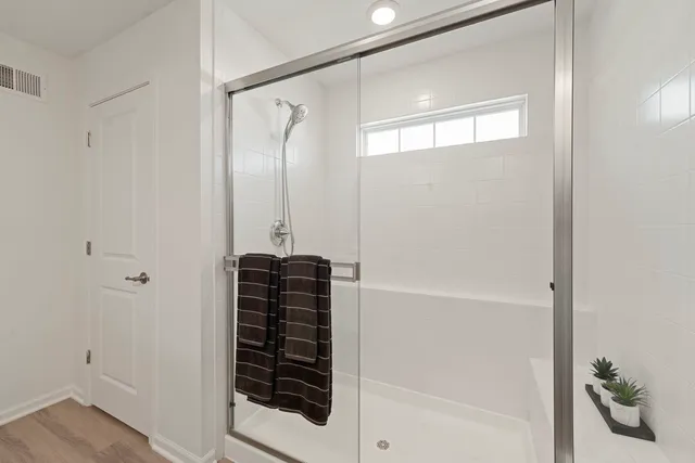 a bathroom with a shower and a mirror