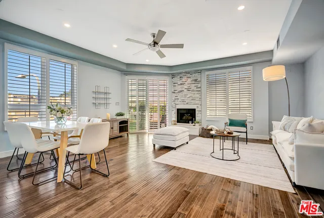 a living room with furniture dining table and a fireplace