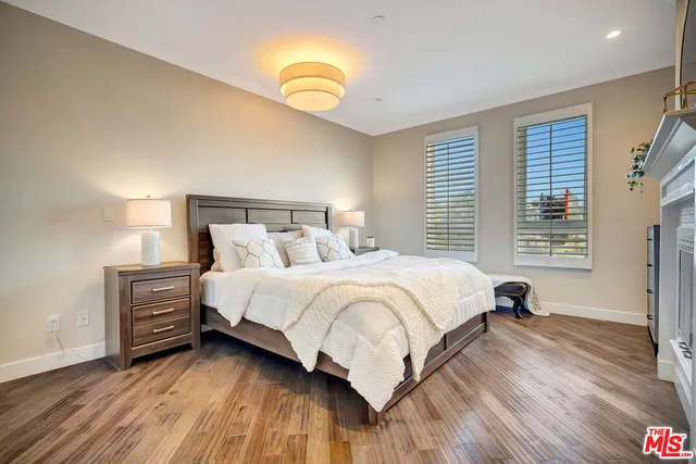 a bedroom with bed and wooden floor