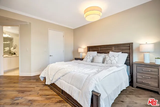 a bathroom with a double vanity sink toilet mirror and bathtub