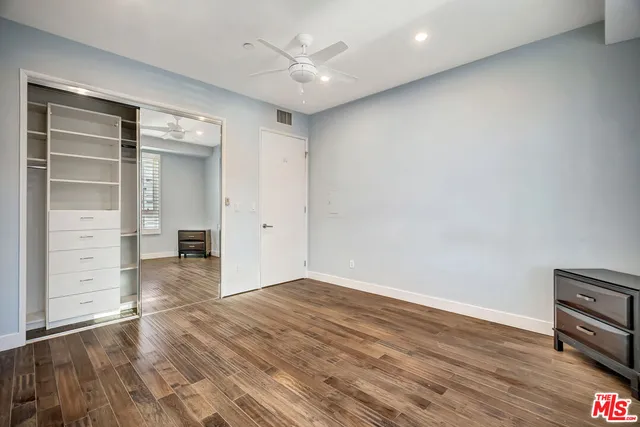 a view of a kitchen with fridge and wooden floor
