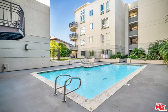 a swimming pool with outdoor seating and yard