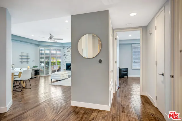 a very nice looking living room with wooden floor and a large window