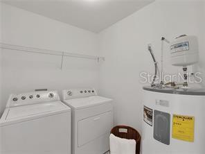 8907 White Sage Loop Lakewood Ranch, FL 34202 - Photo 26 of 33 a utility room with dryer and washer