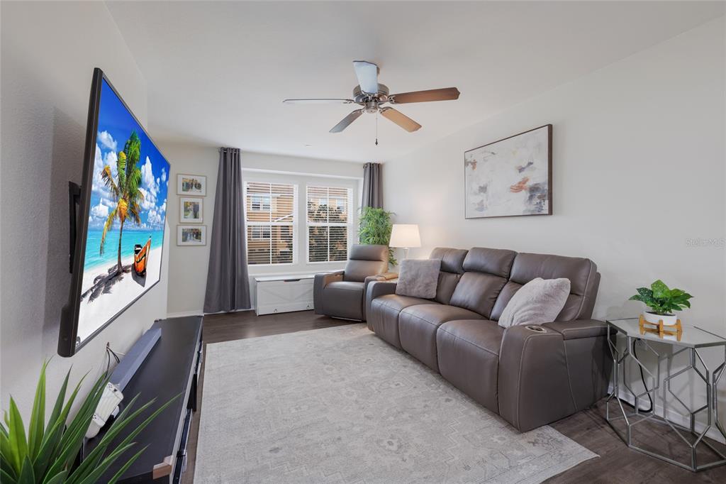 8907 White Sage Loop Lakewood Ranch, FL 34202 - Photo 4 of 33 a living room with furniture ceiling fan and a window
