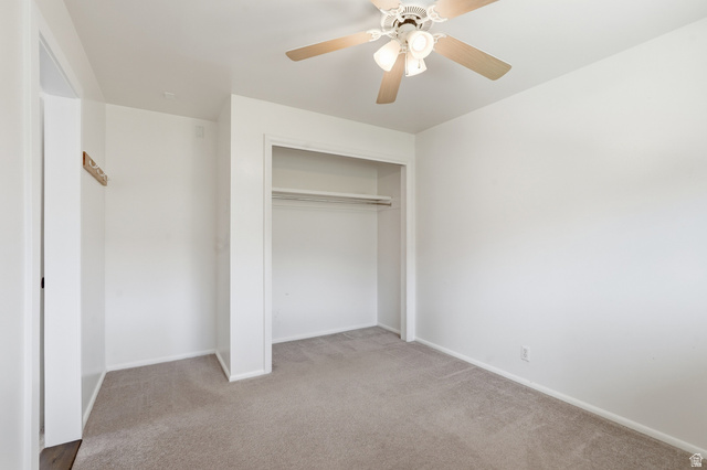 2420 West Old Hwy Road Morgan, UT 84050 - Photo 23 of 54 Unfurnished bedroom with light carpet, ceiling fan, and a closet