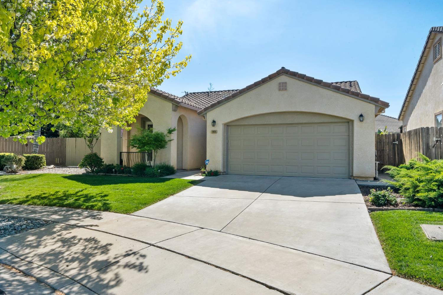 a front view of a house with a yard and a garage