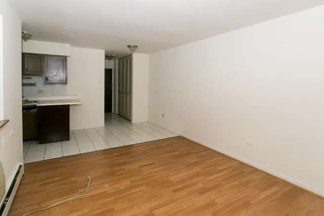 a view of a kitchen with a sink and a refrigerator