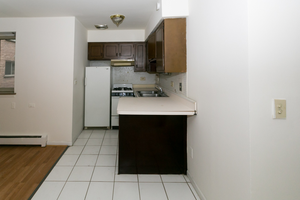 2629 North Hampden Court, Unit 216 Chicago, IL 60614 - Photo 4 of 14 a kitchen with a sink and a stove top oven