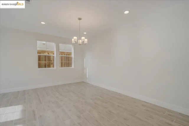 a view of a kitchen with a sink wooden cabinets and a window
