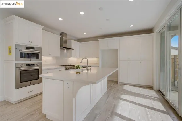 a kitchen with granite countertop a sink stove and refrigerator