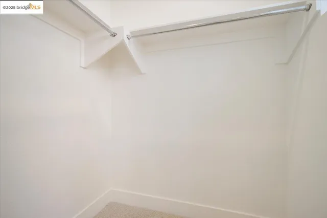 a bedroom with bed and painting on the wall