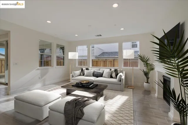 a living room with furniture a fireplace and a flat screen tv