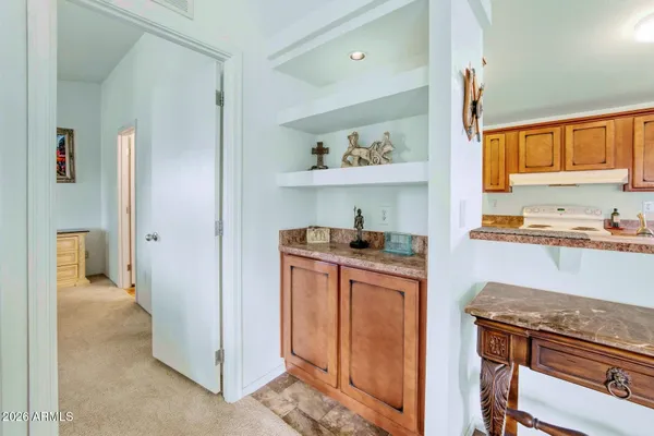 a kitchen with stainless steel appliances granite countertop a refrigerator and a stove