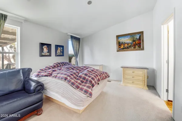 a bedroom with a bed and a couch