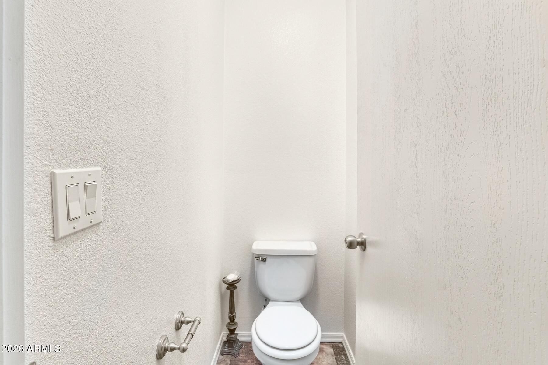 1250 North Fort Grant Road Willcox, AZ 85643 - Photo 18 of 33 a white toilet sitting next to a white wall