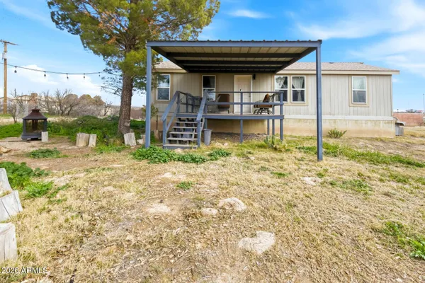 a view of a house with backyard and porch