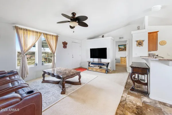 a living room with furniture tv and a window