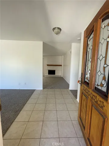 a view of a livingroom with an empty space and a fireplace