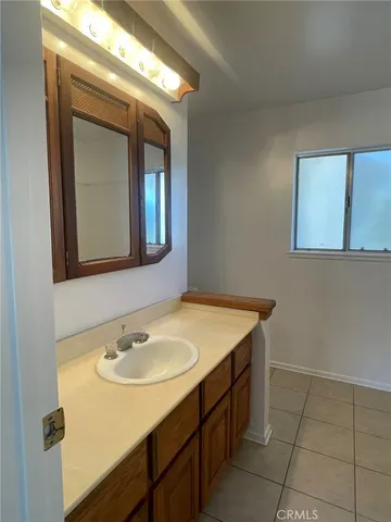 a bathroom with a sink vanity and mirror