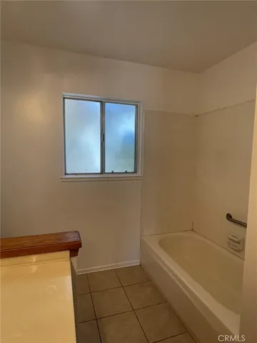 a bathroom with a tub and toilet