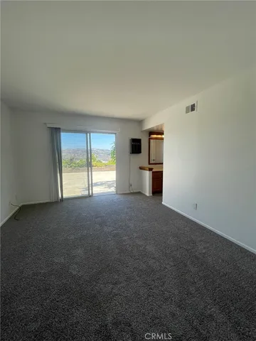 a view of empty room with a fireplace