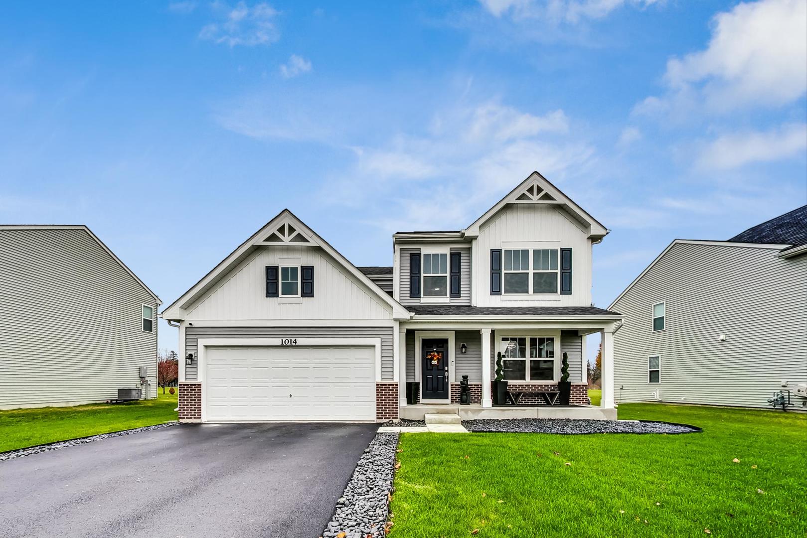 a front view of a house with a yard and porch