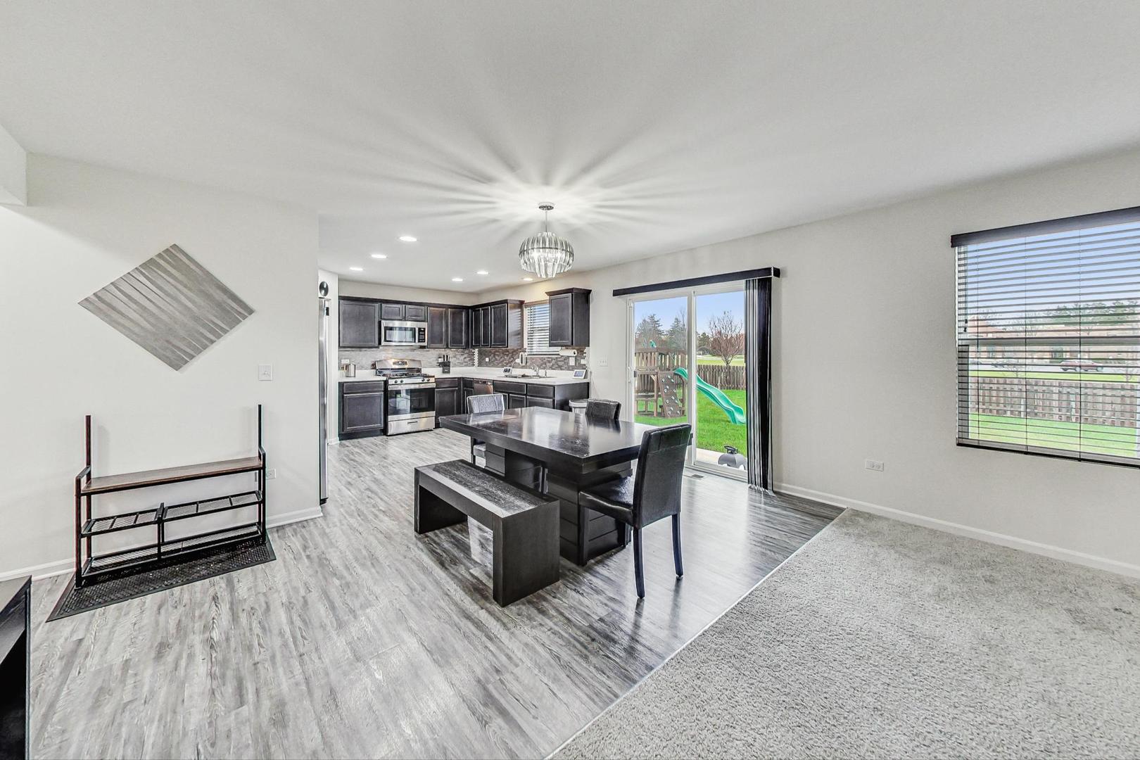 1014 Sharp Drive Plano, IL 60545 - Photo 11 of 52 a living room with furniture and a wooden floor