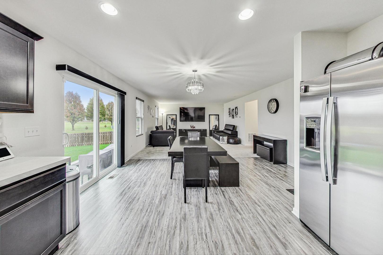 1014 Sharp Drive Plano, IL 60545 - Photo 16 of 52 a living room with furniture wooden floor and a fireplace