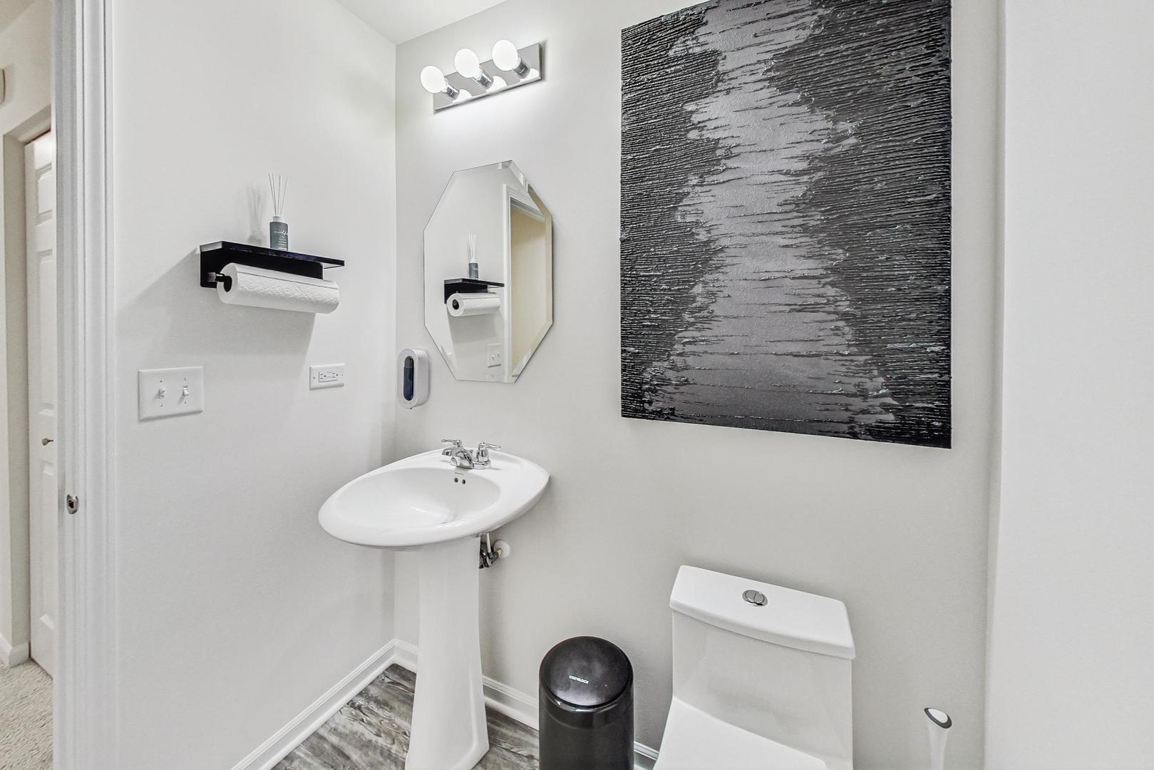 1014 Sharp Drive Plano, IL 60545 - Photo 20 of 52 a bathroom with a toilet sink and mirror