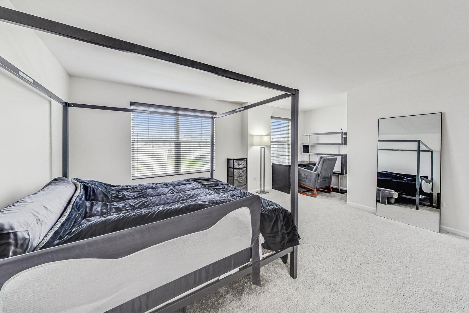 1014 Sharp Drive Plano, IL 60545 - Photo 23 of 52 a bedroom with a bed couch and a window