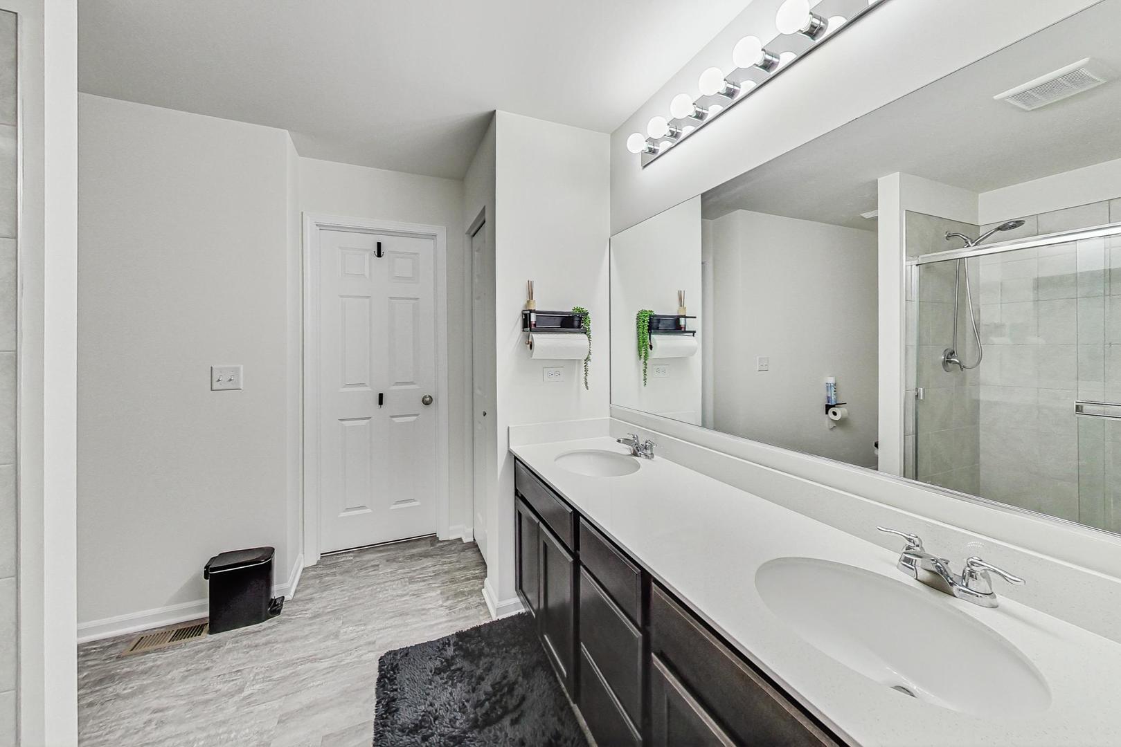 1014 Sharp Drive Plano, IL 60545 - Photo 26 of 52 a spacious bathroom with a double vanity sink and a mirror
