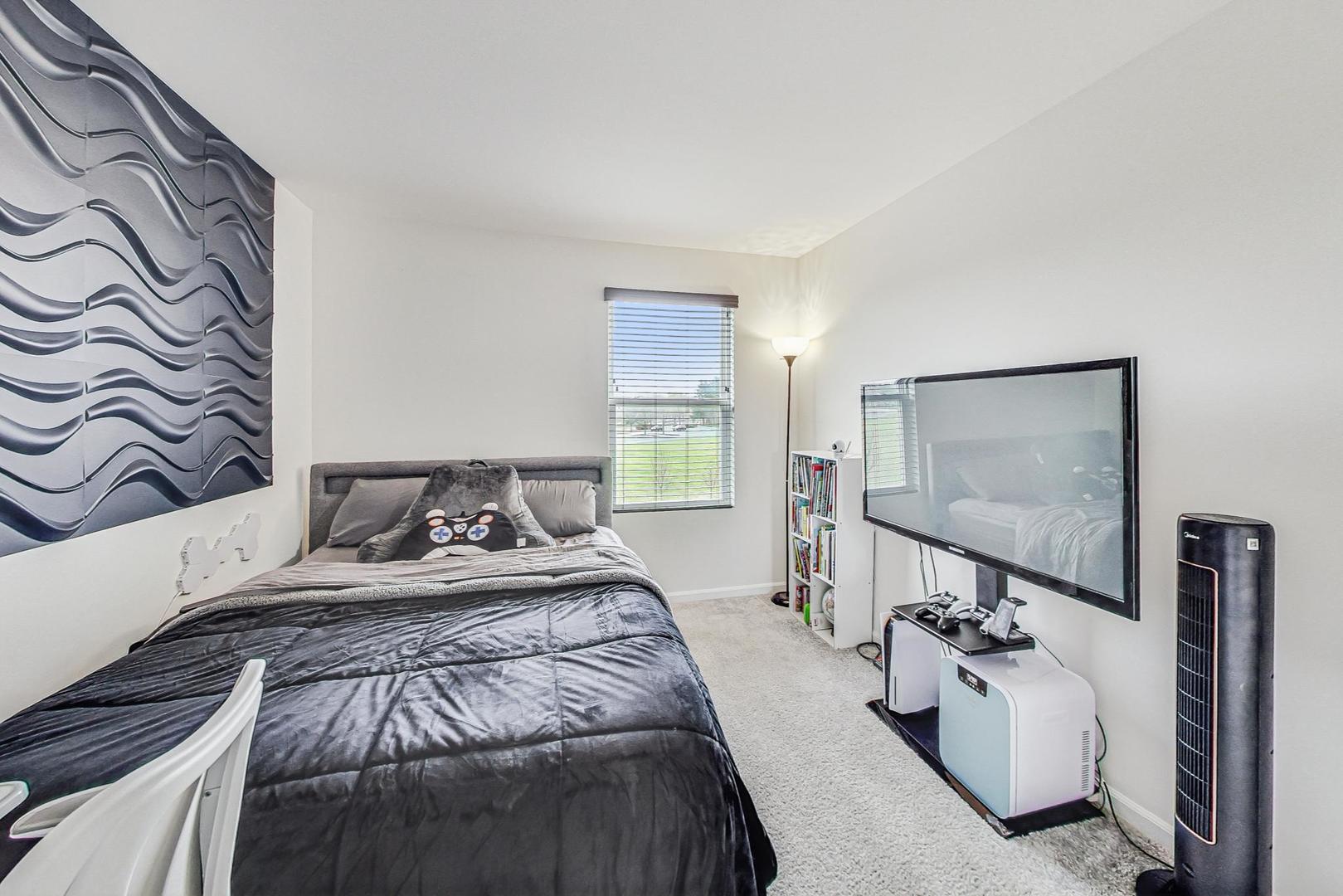 1014 Sharp Drive Plano, IL 60545 - Photo 29 of 52 a bedroom with a bed and a flat screen tv