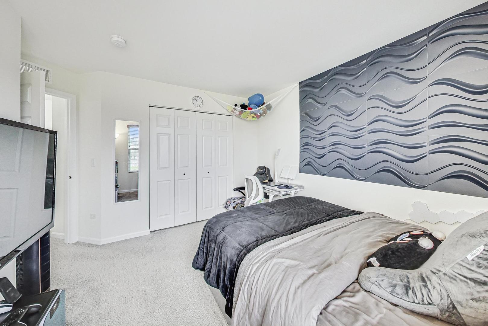 1014 Sharp Drive Plano, IL 60545 - Photo 31 of 52 a bedroom with a bed and a mirror