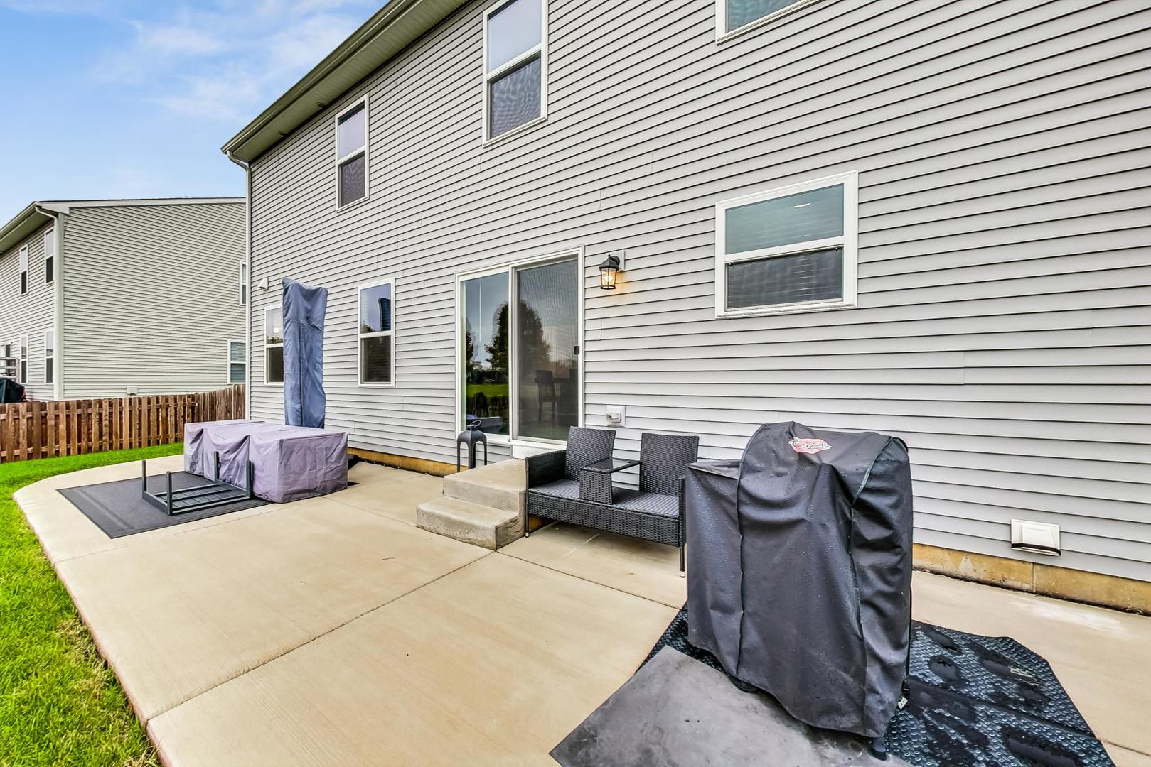 1014 Sharp Drive Plano, IL 60545 - Photo 44 of 52 a view of a patio with couches chairs and potted plants