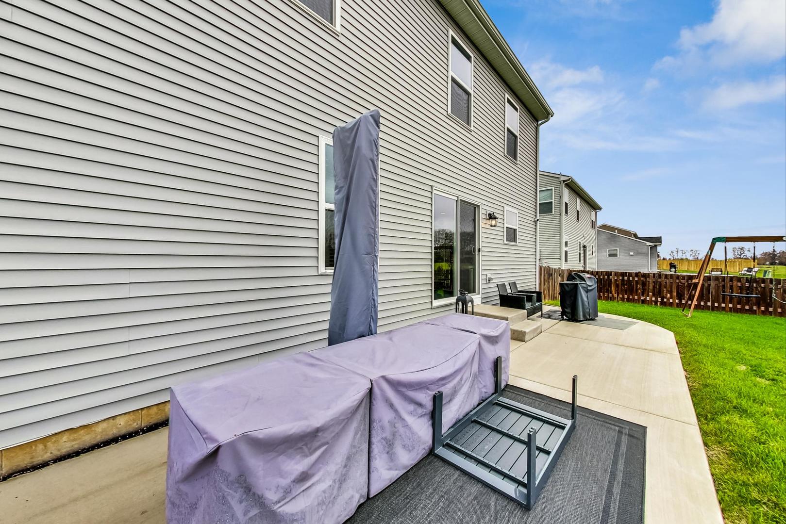 1014 Sharp Drive Plano, IL 60545 - Photo 45 of 52 a patio with table and chairs and potted plants