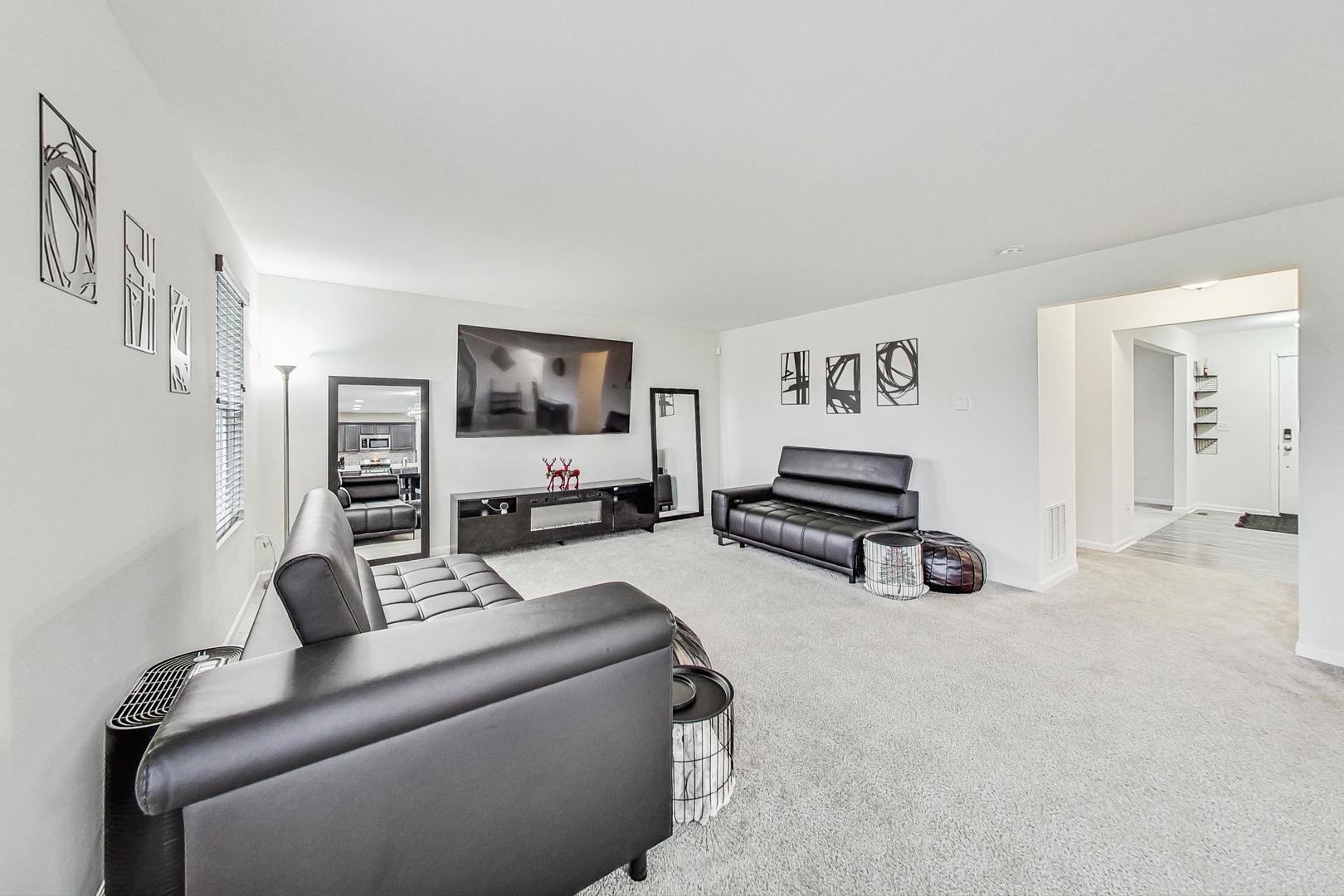 1014 Sharp Drive Plano, IL 60545 - Photo 8 of 52 a living room with furniture and a flat screen tv