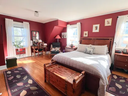 a bedroom with furniture and a large window