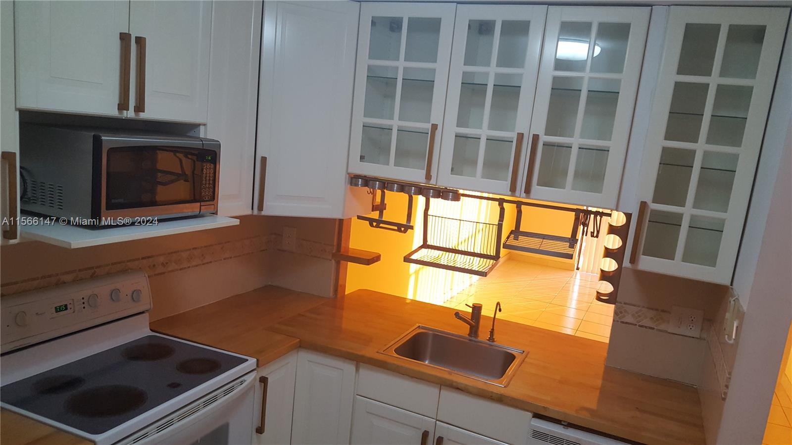 a kitchen with a sink and a microwave