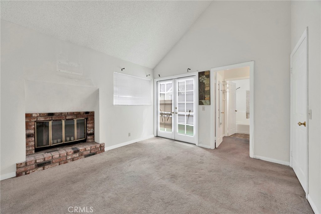 1835 South Alta Vista Avenue, Unit D Monrovia, CA 91016 - Photo 13 of 20 a view of an empty room with a fireplace and a window