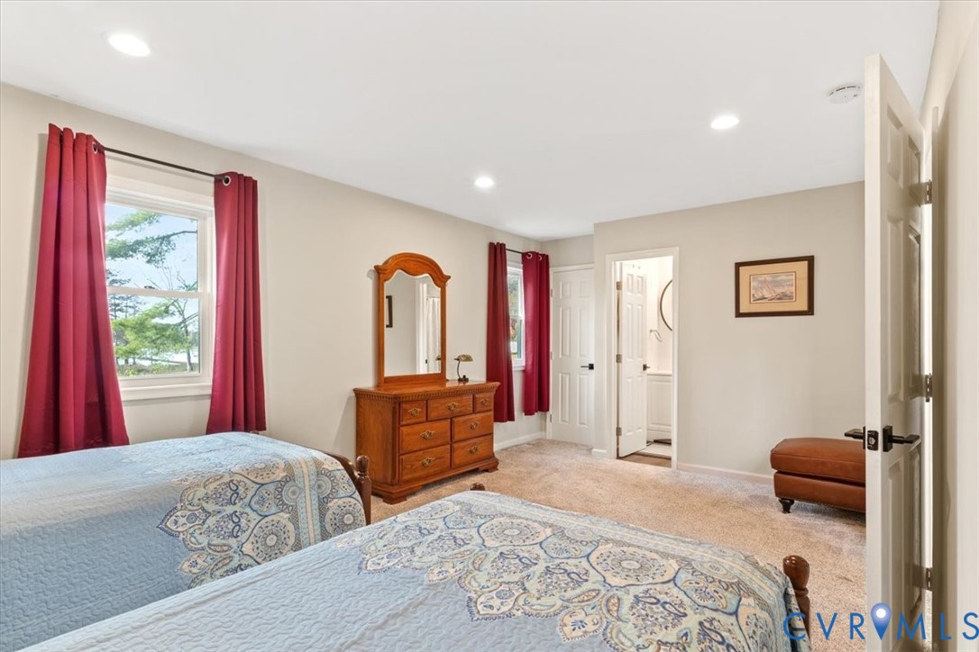 517 West Riverside Drive Lanexa, VA 23089 - Photo 18 of 27 a bedroom with a bed and a dresser with mirror