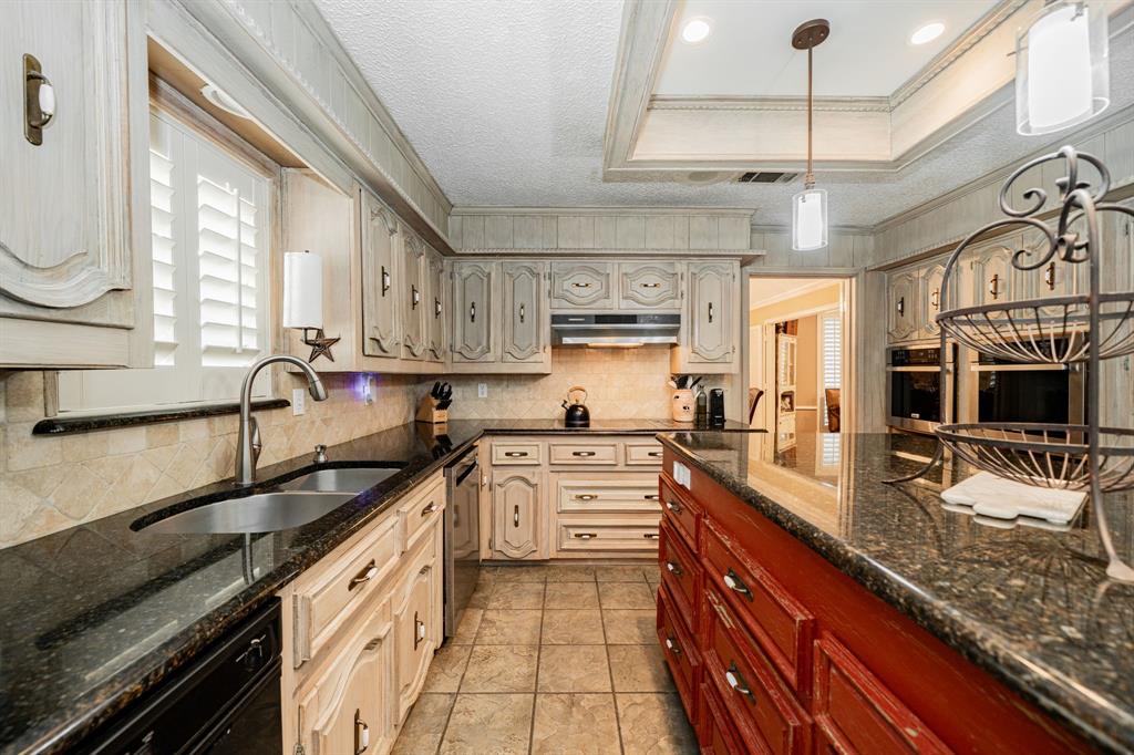 9511 Fallbrook Drive Dallas, TX 75243 - Photo 12 of 40 a kitchen with stainless steel appliances granite countertop a sink stove and cabinets