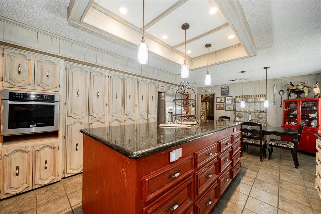 9511 Fallbrook Drive Dallas, TX 75243 - Photo 13 of 40 a kitchen with stainless steel appliances granite countertop a stove and cabinets