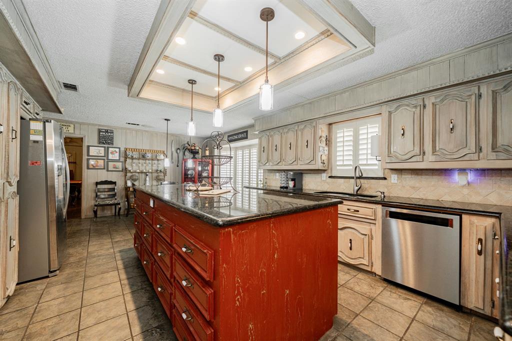 9511 Fallbrook Drive Dallas, TX 75243 - Photo 14 of 40 a kitchen with stainless steel appliances granite countertop a sink and cabinets