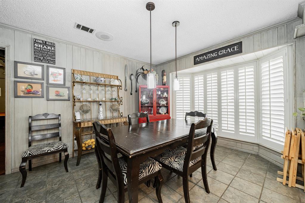 9511 Fallbrook Drive Dallas, TX 75243 - Photo 16 of 40 a view of a dining room with furniture and window