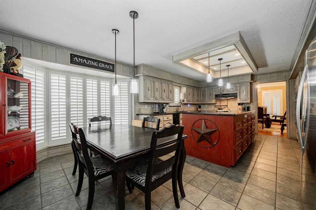 9511 Fallbrook Drive Dallas, TX 75243 - Photo 17 of 40 a open kitchen with stainless steel appliances granite countertop a sink table and chairs